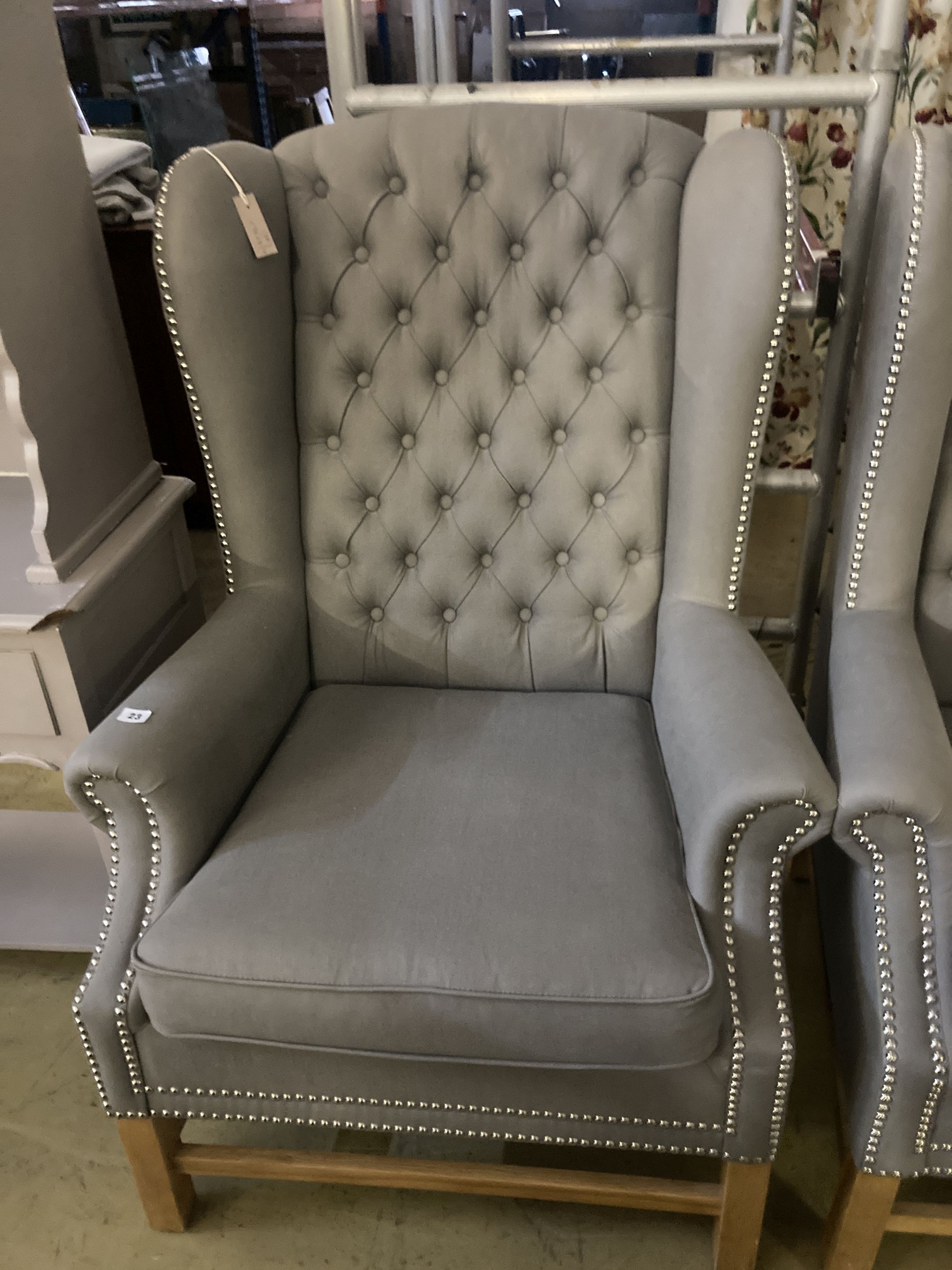 A pair of Victorian style wing armchairs, recently re-upholstered in buttoned grey fabric, width 82cm depth 78cm height 116cm